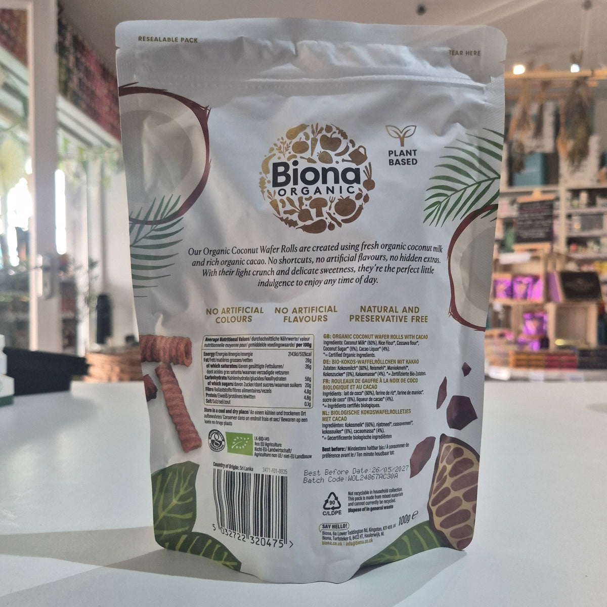 Biona coconut product packaging on a white surface with a blurred background