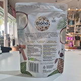 Biona coconut product packaging on a white surface with a blurred background