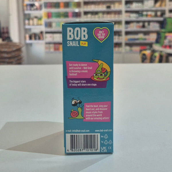 Bob Snail toy packaging on a table with a blurred store background