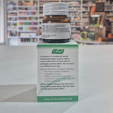 A bottle and its packaging of A.Vogel Prostasan on a shelf in a pharmacy.