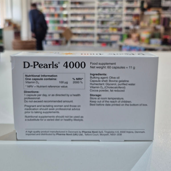 Box of D-Pearls 4000 supplement with nutritional information on a blurred store background