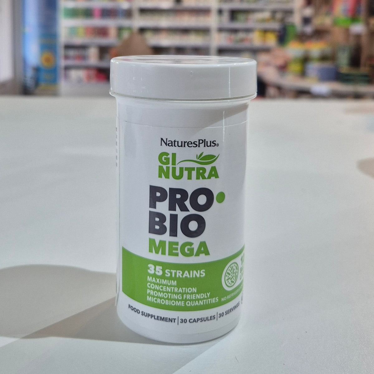 Probiotic supplement container on a shelf with a blurred store background
