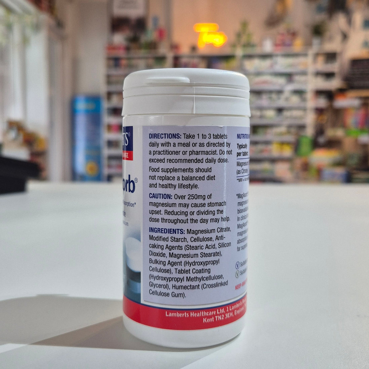 Supplement container with label on a counter in a store setting