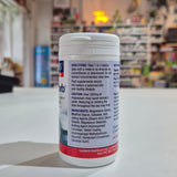 Supplement container with label on a counter in a store setting