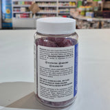 Bottle of magnesium gummies with a label held in front of a store shelf.