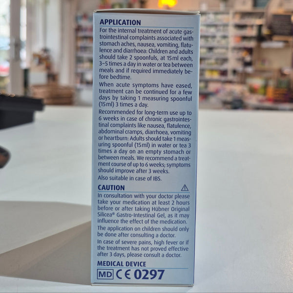 Packaging of Hubner Original Silicea Gi Gel 200Ml for gastro-intestinal complaints, displaying indications such as nausea, vomiting, flatulence, diarrhoea, stomach aches, and heartburn in a shop, on a counter, application instructions. 