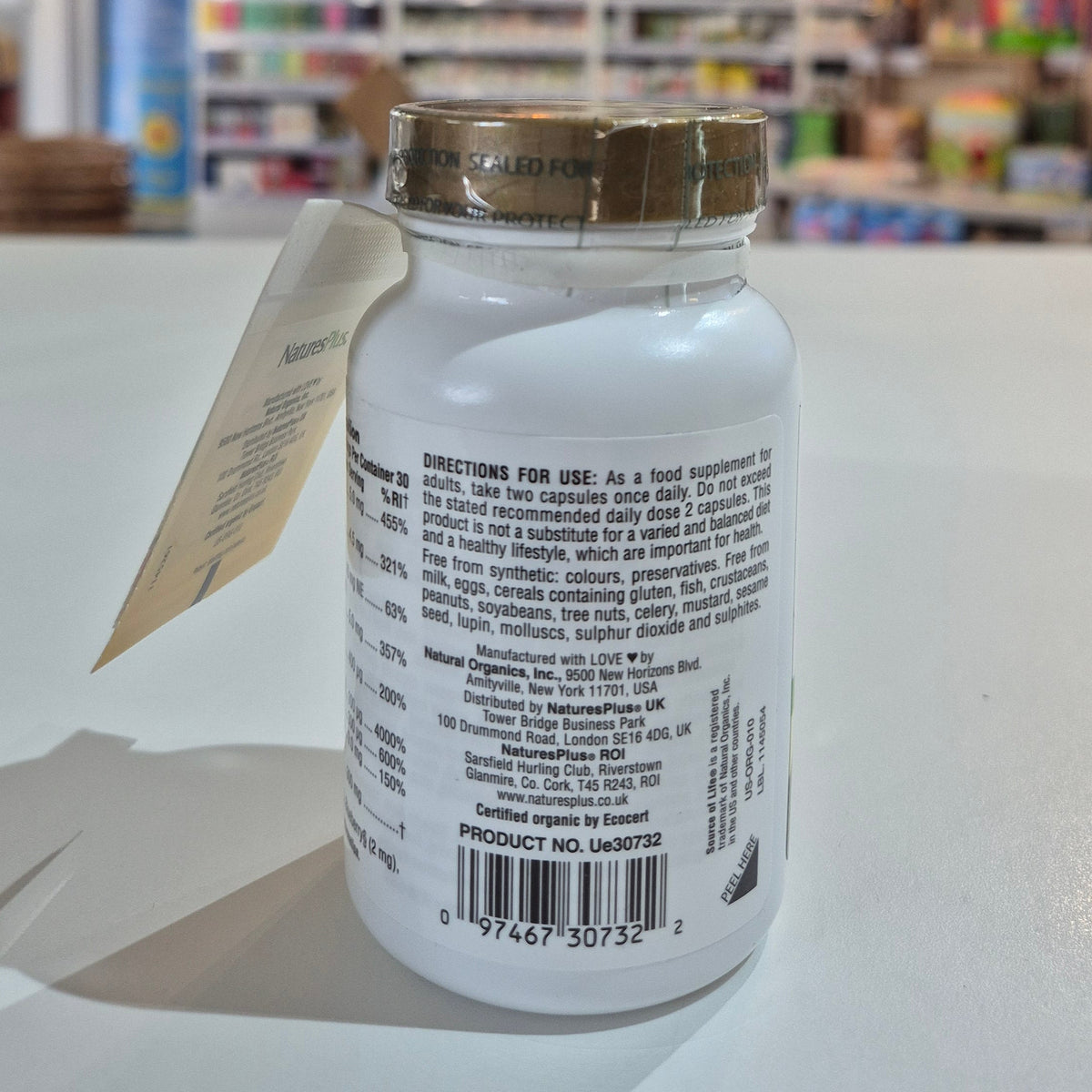 Supplement bottle with label and barcode on a white surface