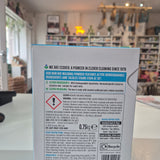 Product label with text and symbols on a blurred indoor background