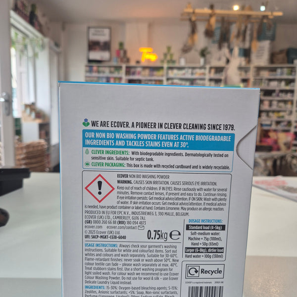 Product label with text and symbols on a blurred indoor background