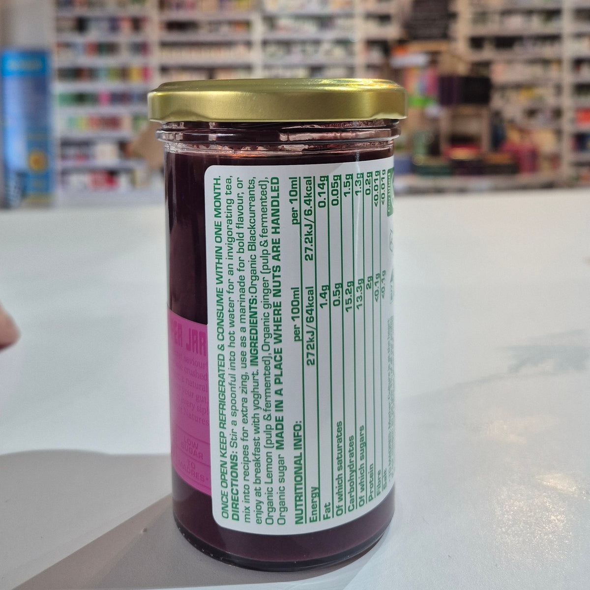 Close-up of a product label with a blurred store interior in the background