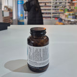 Bottle with label on a white surface, blurred background