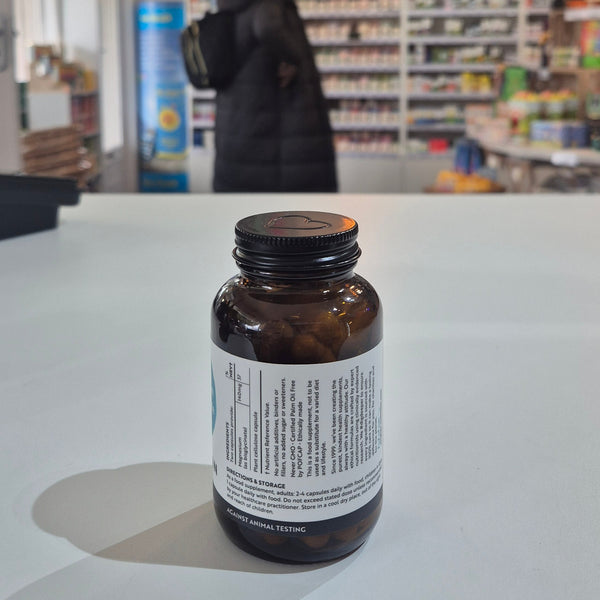 Bottle with label on a white surface, blurred background