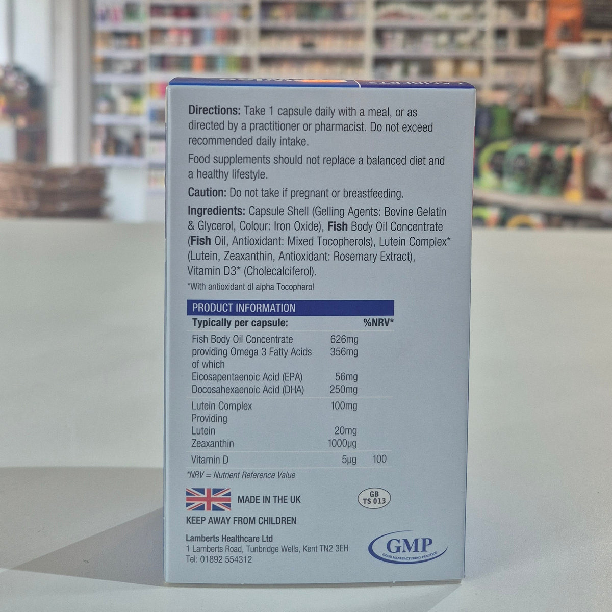 Supplement package with detailed directions and product information on a blurred background