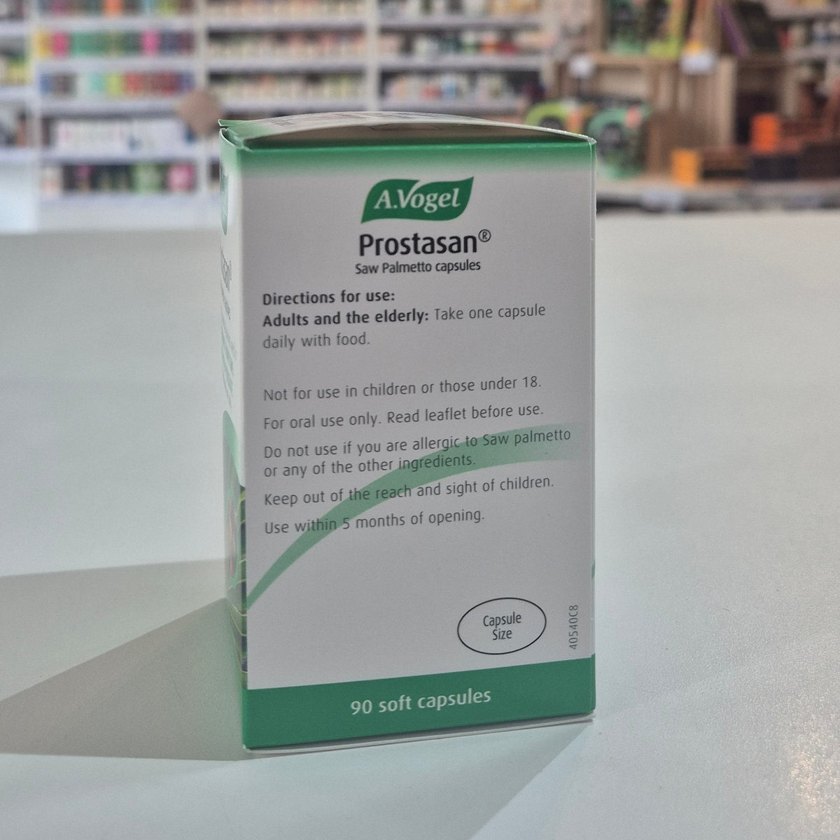 Box of A Vogel Prostasan capsules on a counter with a blurred store background
