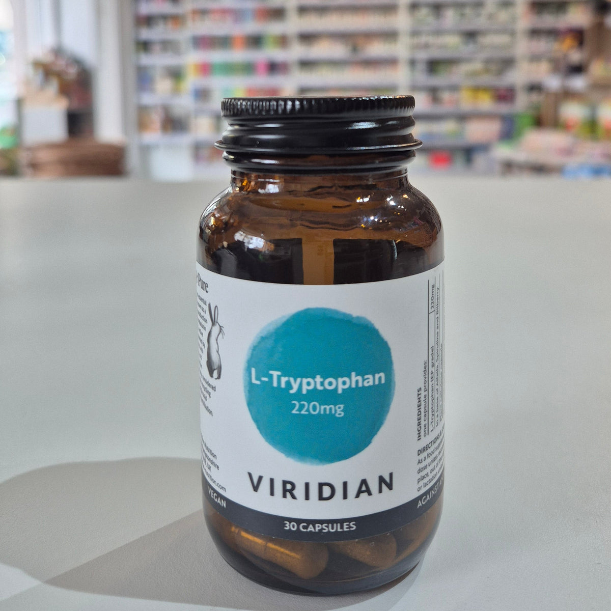 Bottle of Viridian L-Tryptophan on a shelf with a blurred store background