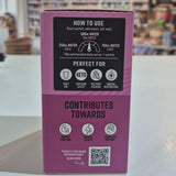 Product packaging with text and QR code on a blurred indoor background