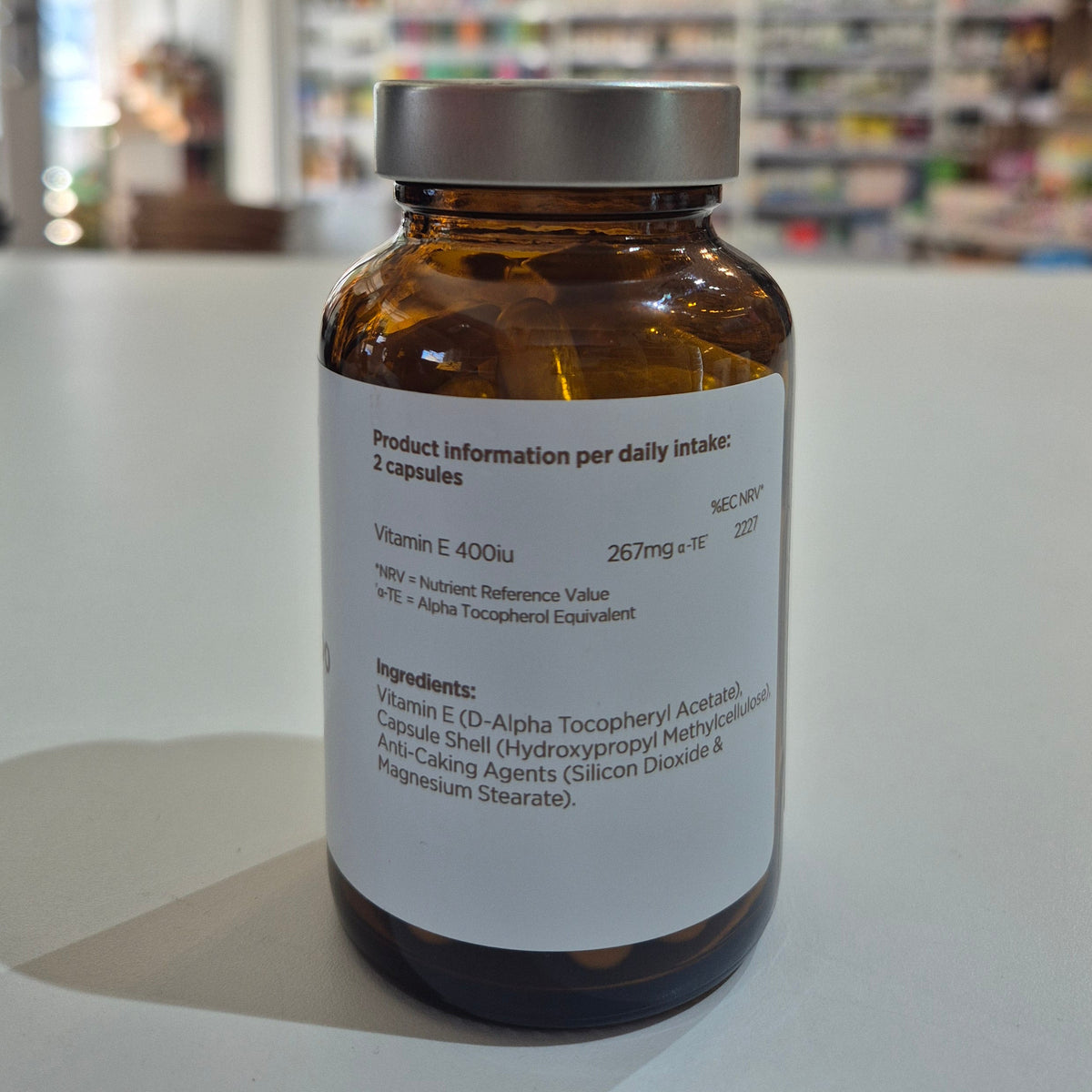 Vitamin supplement bottle with label on a white surface