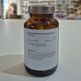 Vitamin supplement bottle with label on a white surface