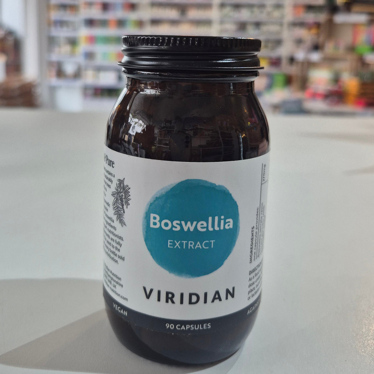 Bottle of Boswellia extract by Viridian on a white surface with a blurred background