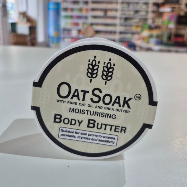 OatSoak body butter container with a blurred store background