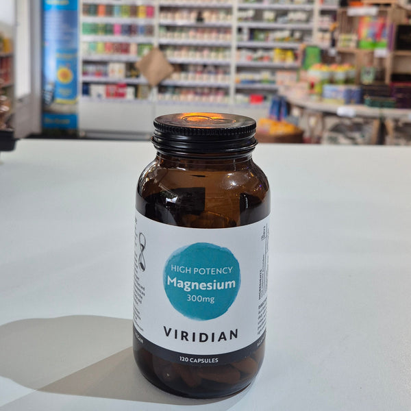 Bottle of Viridian supplements on a white surface with a blurred background