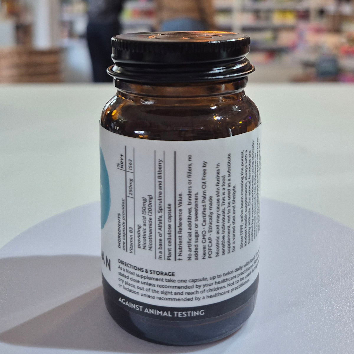 Brown supplement bottle with label on a white surface