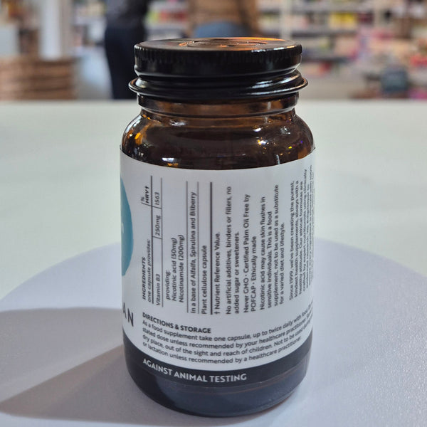 Brown supplement bottle with label on a white surface