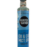 Bottle of Hunter & Gather MCT oil with a blue label on a white background. 