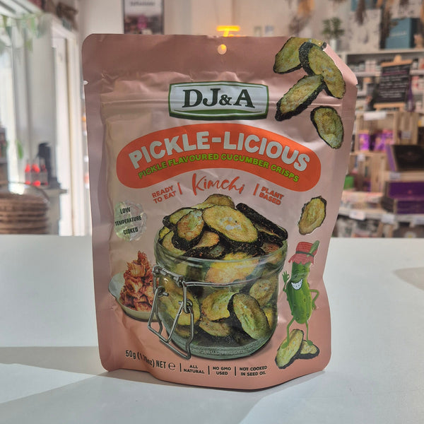 A stand-up pouch of DJ&A Pickle-Licious Kimchi pickles sitting on a white shop interior.