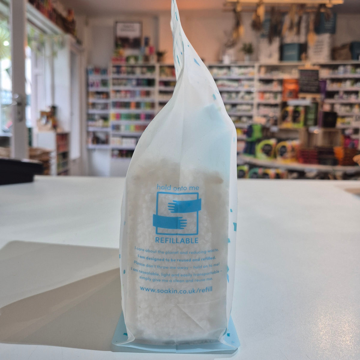 Package of Soakin Dead Sea Salt with branding and product description on a light speckled background