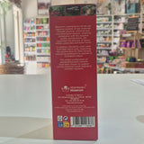 The back of a red Bioserum Laboratories cosmetic box, showing product information and a barcode, photographed on a white tabletop with a blurred store background.