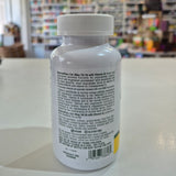 NaturesPlus Cal/Mag/Vit D3 supplement bottle on a table with a blurred store background. Supplement bottle with label on a blurred store background