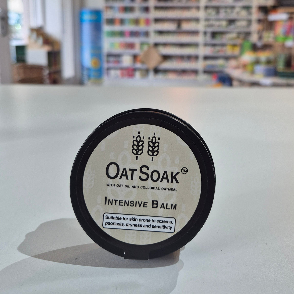Container of Oat Soap Intensive Balm with a blurred background