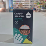 Copper Scourers packaging with a blurred store interior in the background