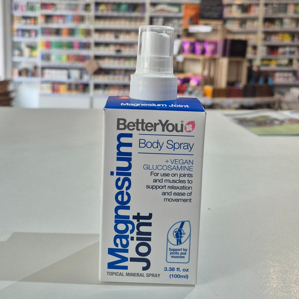 BetterYou Magnesium Joint Body Spray bottle on a surface with a blurred store background
