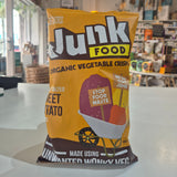 Junk Food Organic Vegetable Crisps packaging on a white surface with a blurred background
