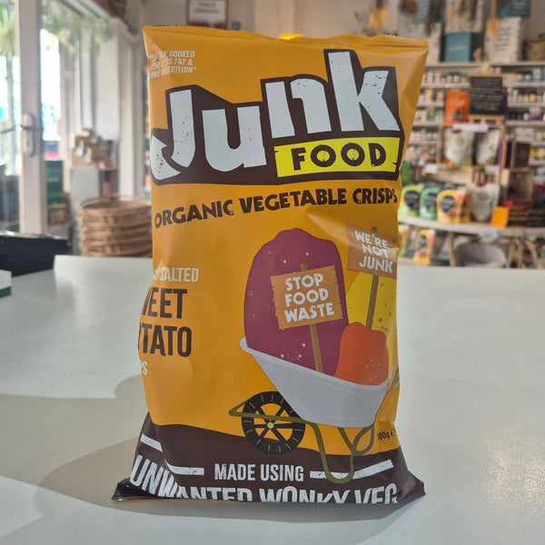 Junk Food Organic Vegetable Crisps packaging on a white surface with a blurred background
