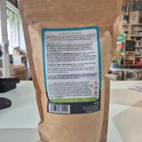 Kraft paper bag with a label on a blurred indoor background