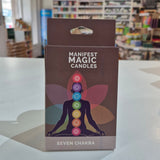 Box of Manifest Magic Candles with colorful design on a shelf.
