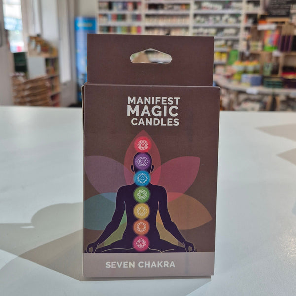 Box of Manifest Magic Candles with colorful design on a shelf.