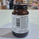 Vitamin B3 supplement bottle with 'Viridian' label on a blurred store background. Brown glass bottle with a label on a white surface, blurred background