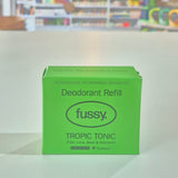 Green deodorant refill box labeled 'fussy' with a store shelf in the background