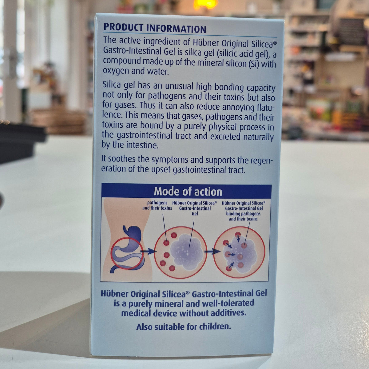 Packaging of Hubner Original Silicea Gi Gel 200Ml for gastro-intestinal complaints, displaying indications such as nausea, vomiting, flatulence, diarrhoea, stomach aches, and heartburn in a shop, on a counter back of the packet