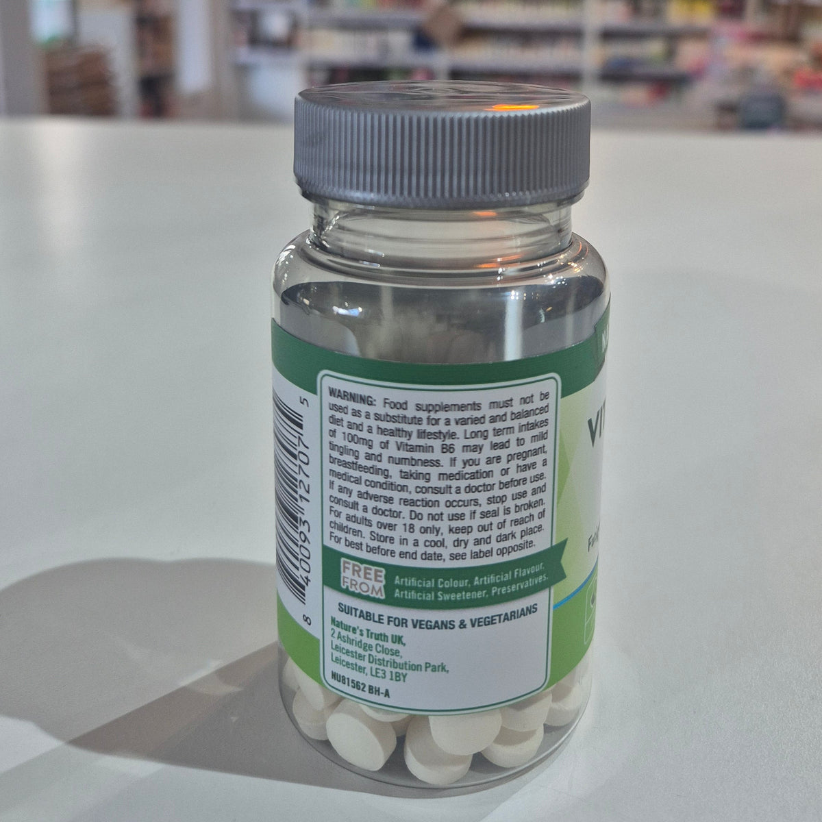 Bottle of dietary supplements with a label on a white surface