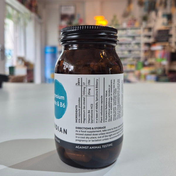 Bottle of Viridian Magnesium Citrate & B6 supplement on a white surface with a blurred store background with label on a white surface, blurred store background