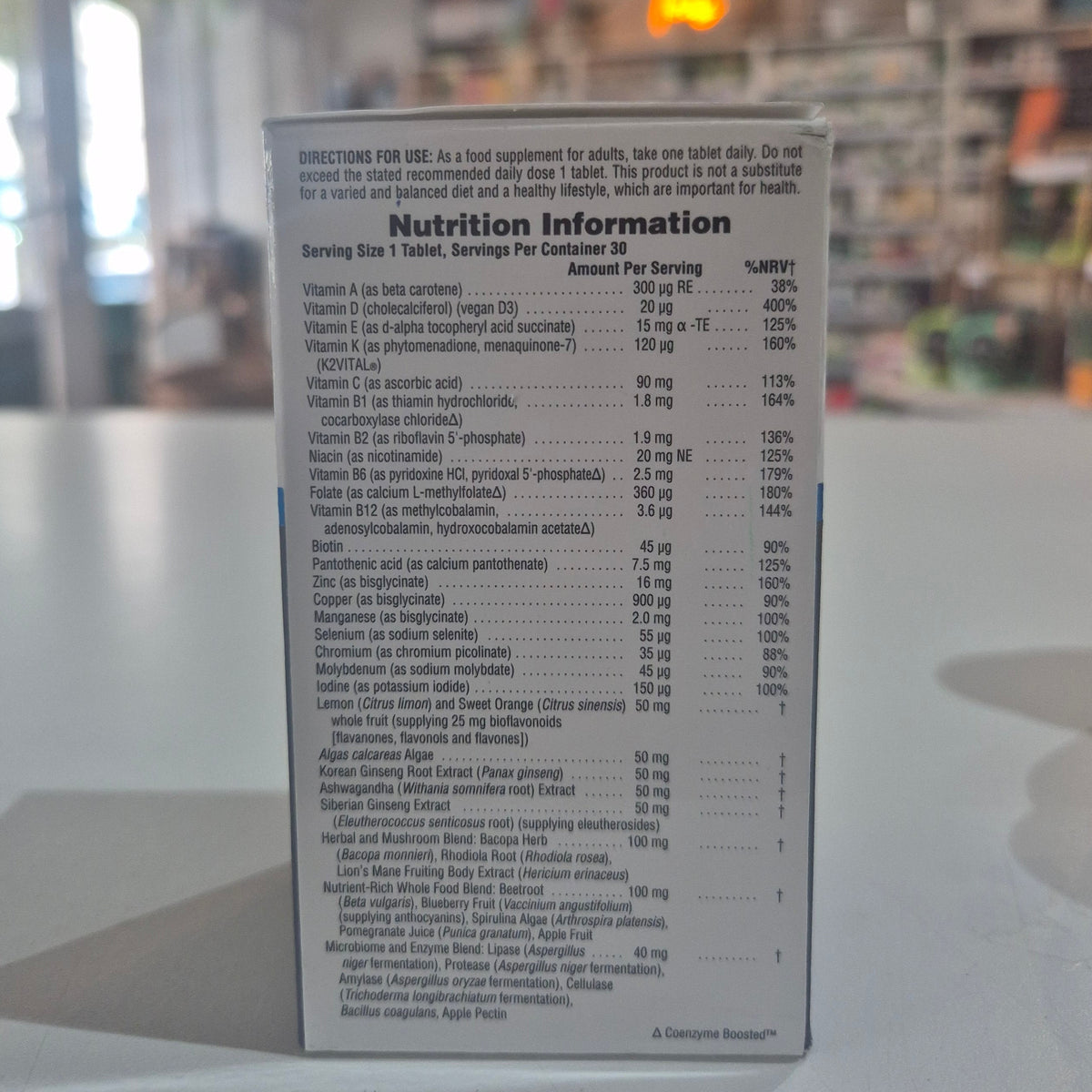 Nutrition information label on a supplement package with a blurred background