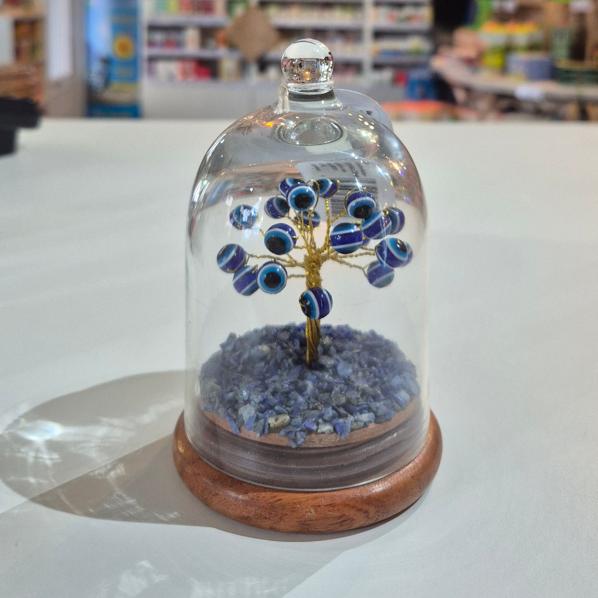 Decorative tree with blue floral design on a white door, blurred interior background