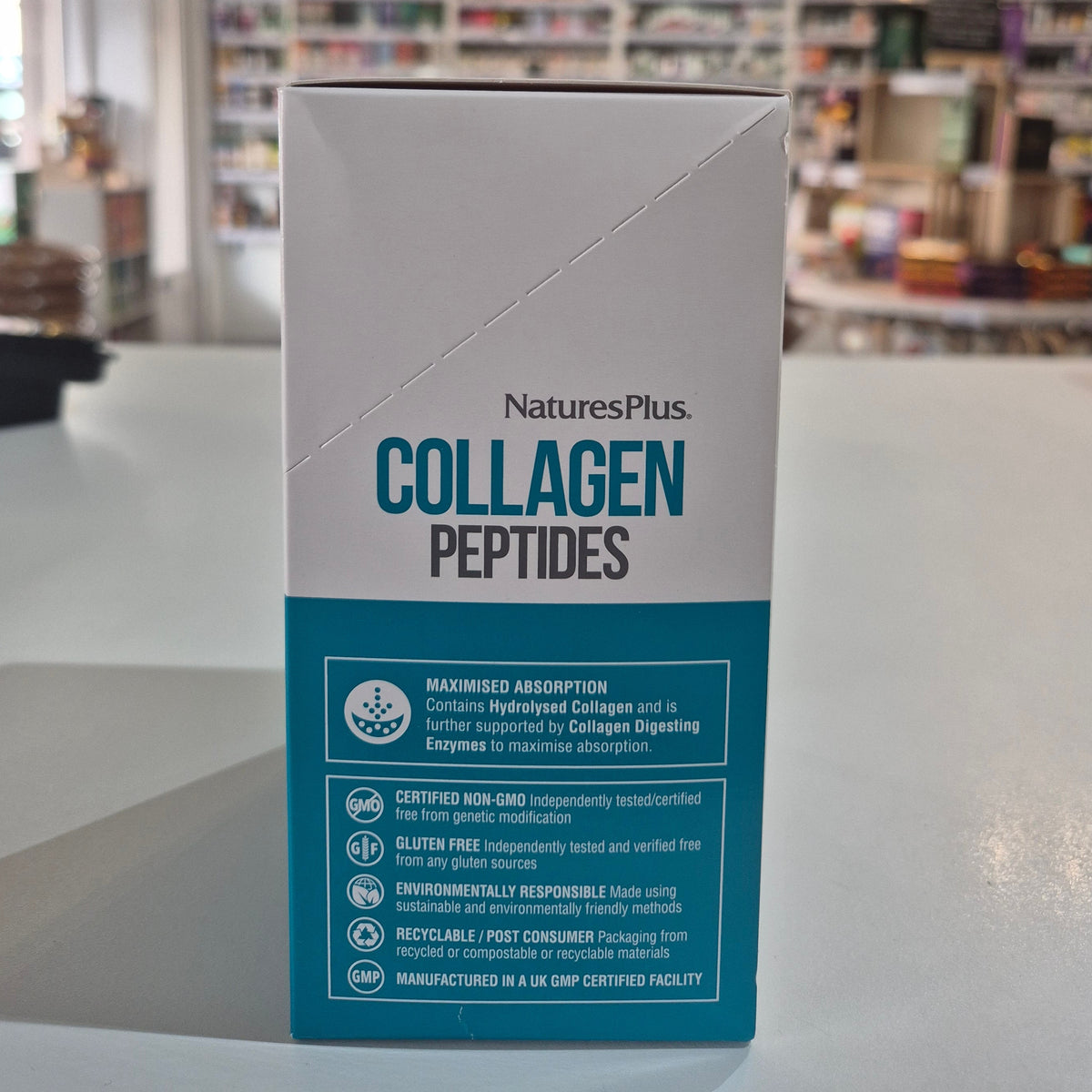 Box of NaturesPlus Collagen Peptides on a table with a blurred background