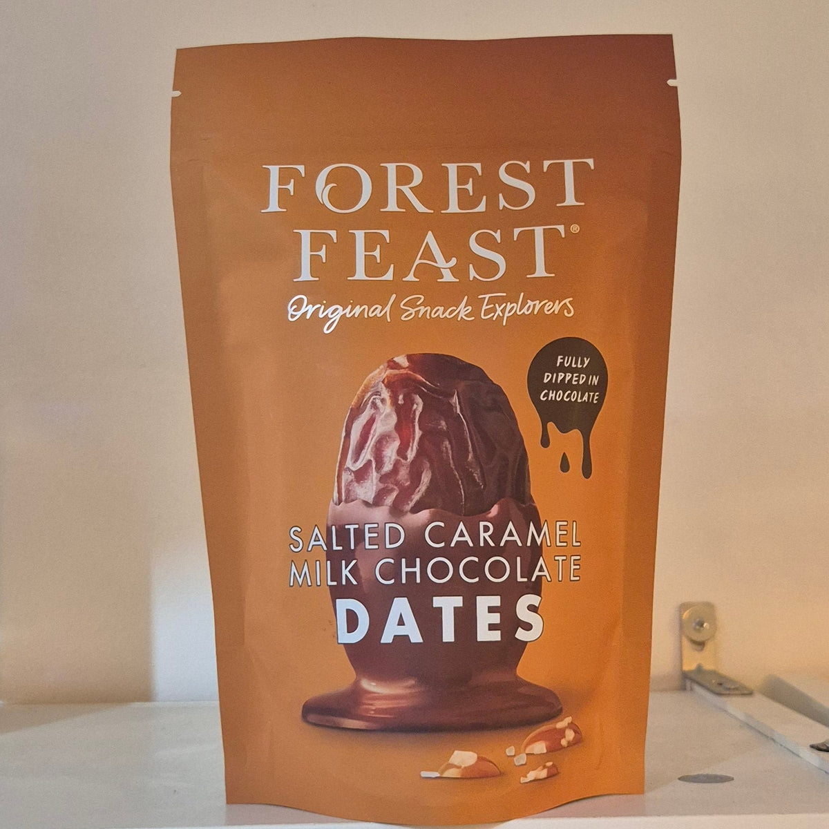 Bag of Forest Feast salted caramel milk chocolate dates on a neutral background
