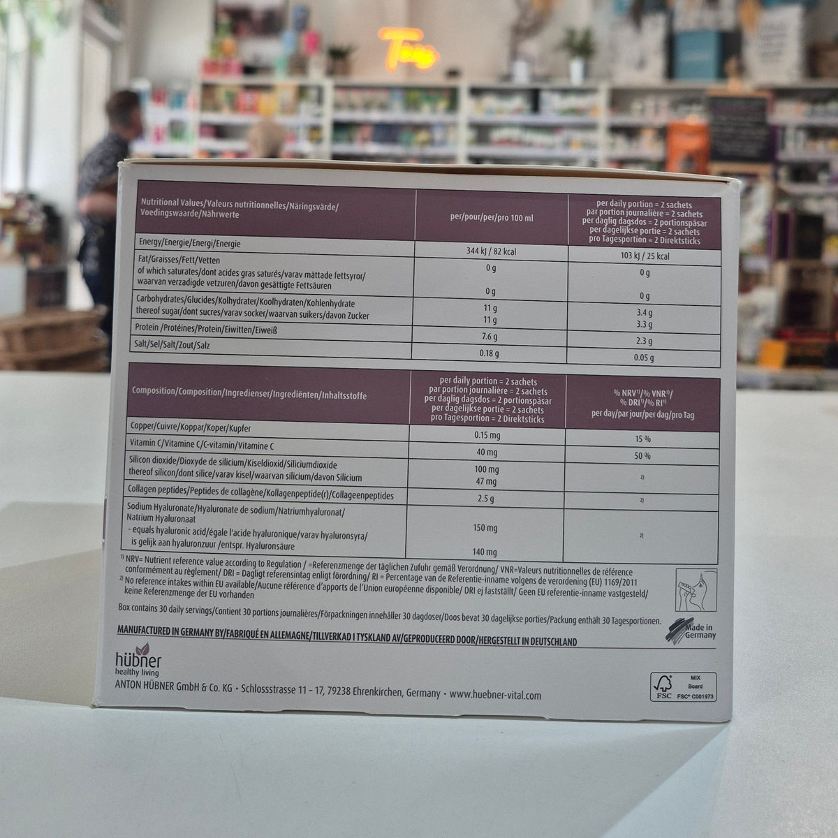 Nutritional information label on a product packaging with a blurred background of a store.
